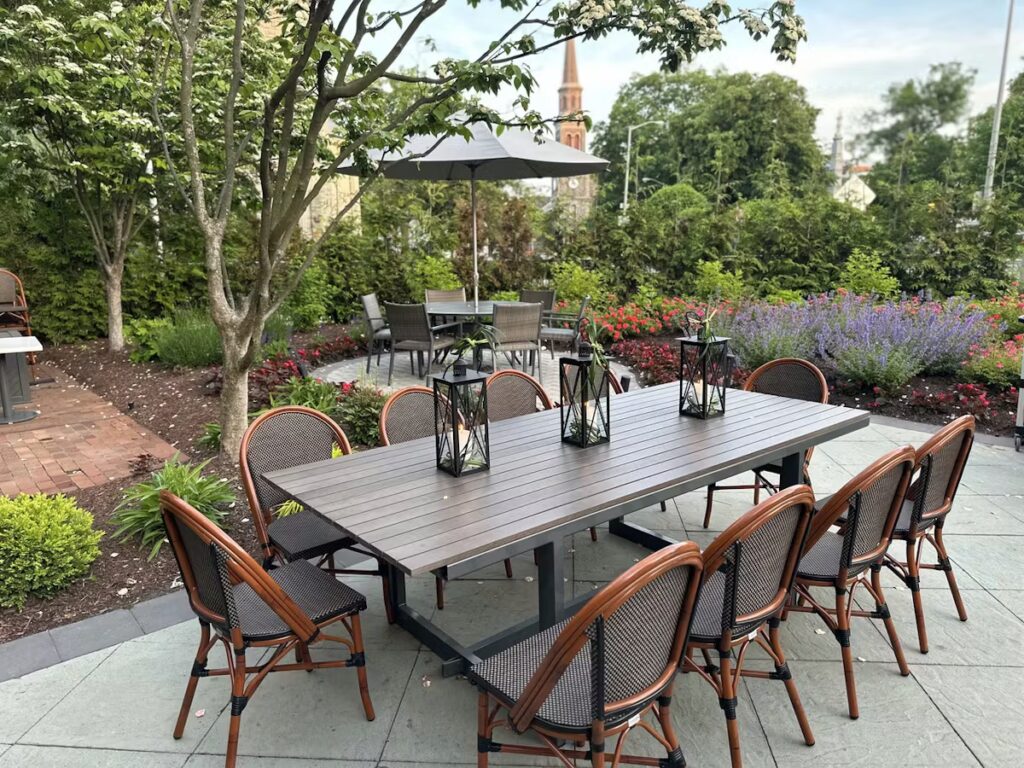 Outdoor patio dining area with garden lighting