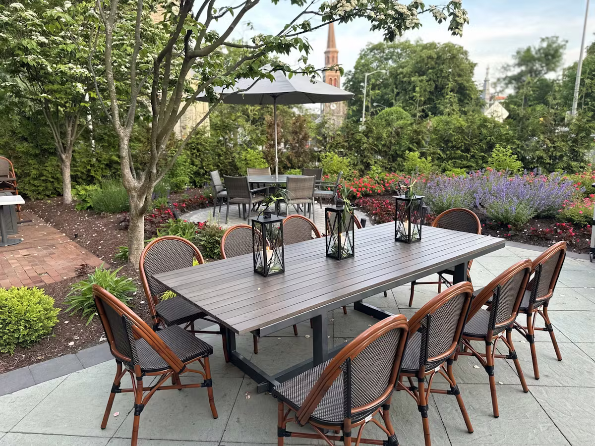 Outdoor patio dining area with garden lighting